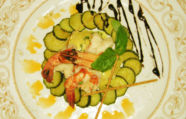 Pan fried prawns with thyme and ginger upon a bed of artichokes and a crown of courgettes